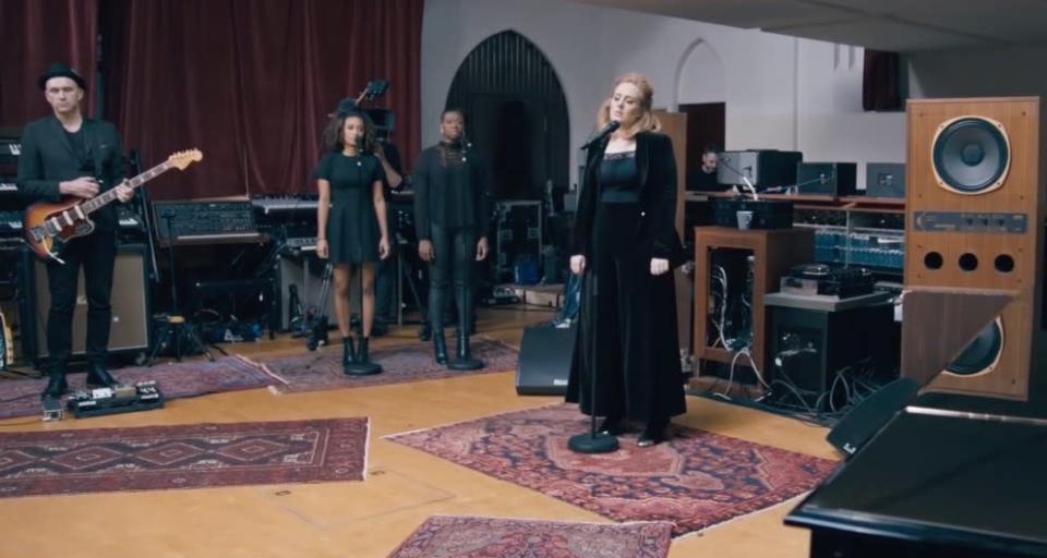 Adele performing “When We Were Young” live at The Church Studios in London wearing a velvet suit. 