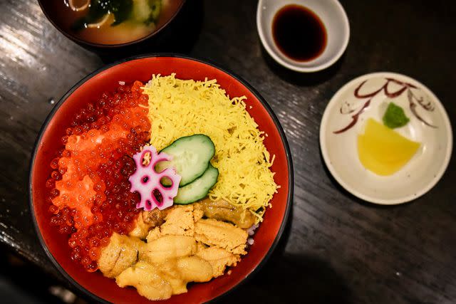 <p>Nanno Betts</p> A bowl of rice topped with a variety of sashimi at Omicho Market.