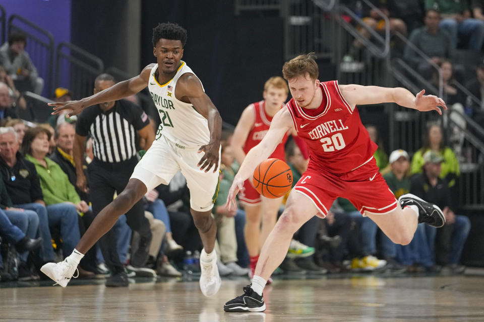 Baylor center Yves Missi (21) and Cornell forward Sean Hansen (20) compete for the ball during the first half of an NCAA college basketball game, Tuesday, Jan. 2, 2024, in Waco, Texas. (AP Photo/Julio Cortez)