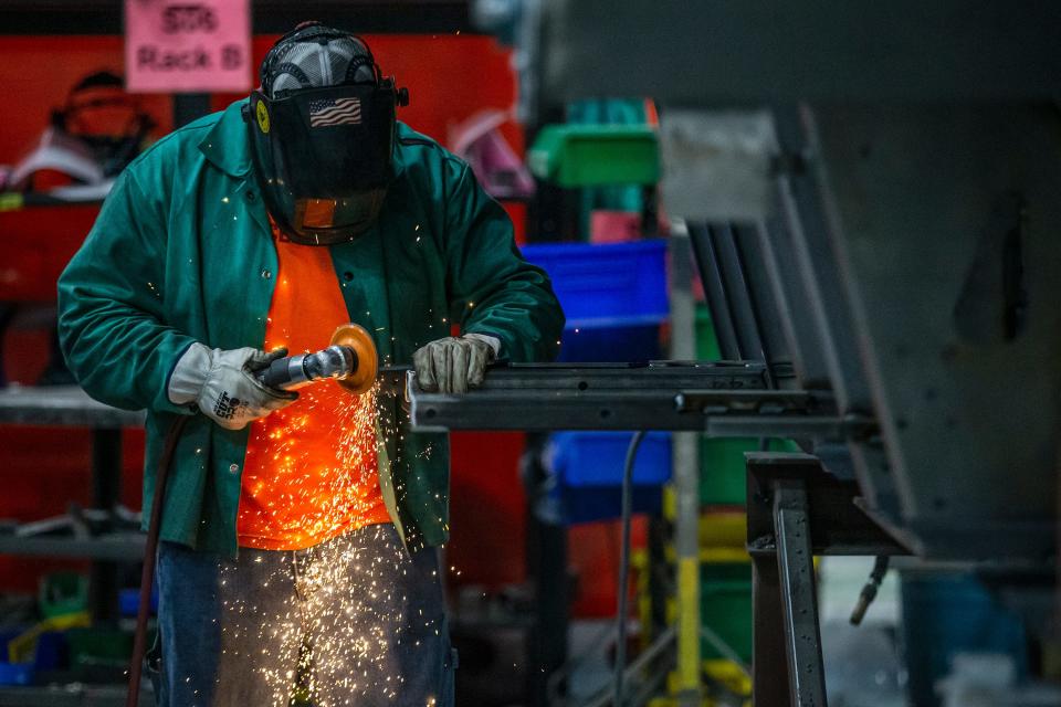 Clayton Heck, a welder fabricator for Cemen Tech, works inside the volumetric concrete mixer manufacturing facility in Indianola