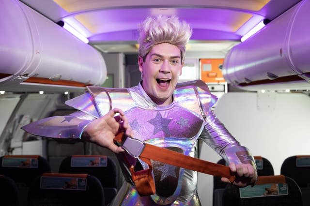 A cabin crew member recreating the outfits worn by Jedward