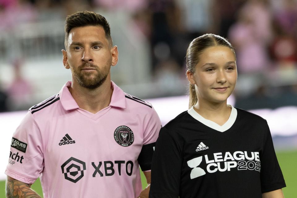 Inter Miami forward Lionel Messi (10) steps out on the field with Harper Beckham, during the Leagues Cup match between Inter Miami CF and Charlotte FC on August 11, 2023 at DRV PNK Stadium in Fort Lauderdale, FL.