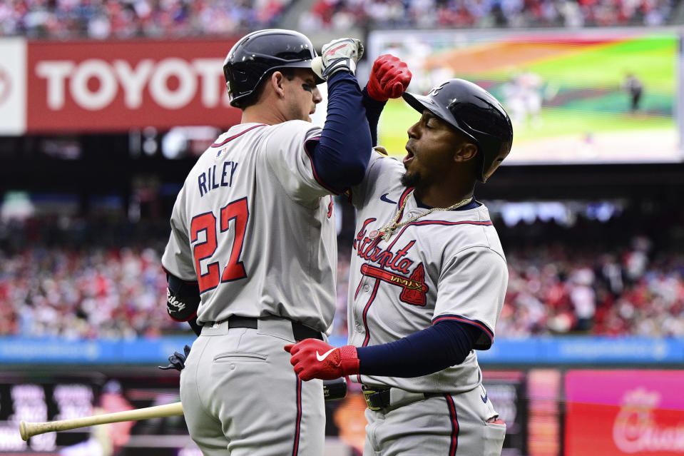 Atlanta Braves' Ozzie Albies, right, celebrates his two-run home run with Austin Riley (27) during the first inning of a baseball game against the Philadelphia Phillies, Saturday, March 30, 2024, in Philadelphia. (AP Photo/Derik Hamilton)