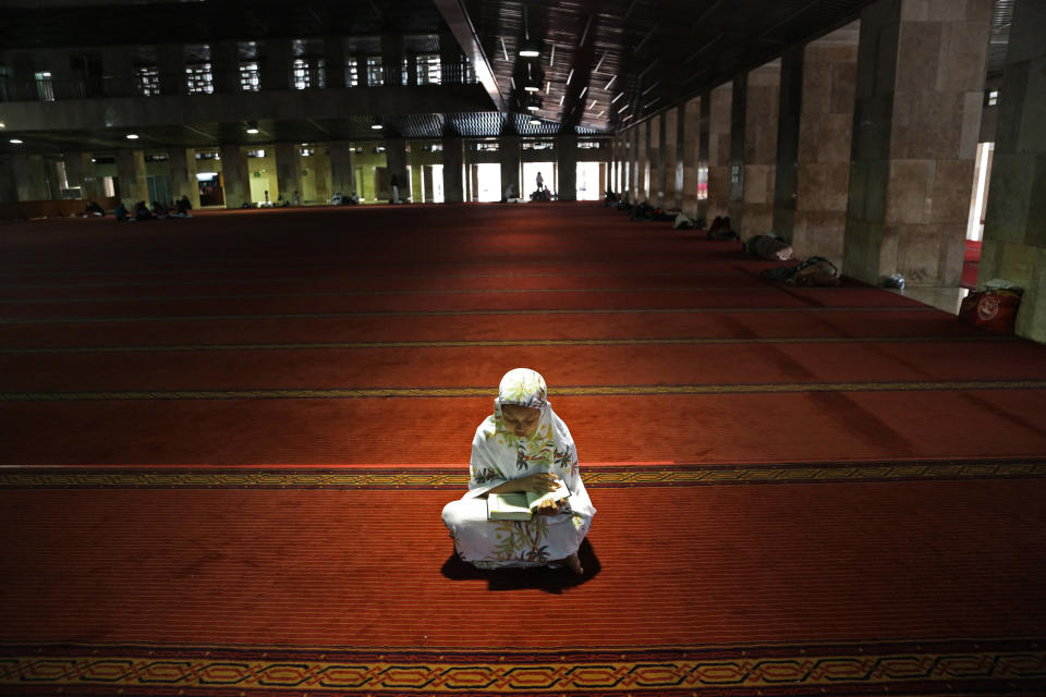 Muslim woman reads the Quran