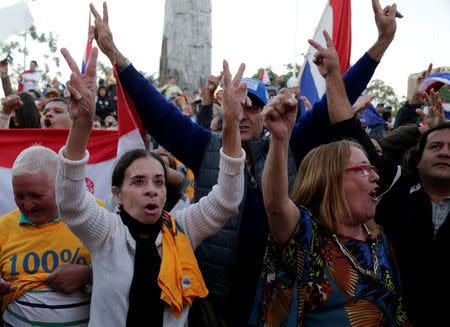 People celebrate the rejection of a proposed amendment to allow presidential second terms, in front of the Paraguayan Congress, in Asuncion, Paraguay April 26, 2017. REUTERS/Jorge Adorno