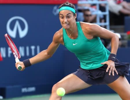 Aug 10, 2018; Montreal, Quebec, Canada; Caroline Garcia of France hits a shot against Simona Halep of Romania (not pictured) during the Rogers Cup tennis tournament at Stade IGA. Mandatory Credit: Jean-Yves Ahern-USA TODAY Sports