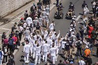 Mariia Vysochanska of Ukraine, accompanied by 27 EU athletes and paraathletes, participates in the Olympic torch relay in Marseille, southern France, Thursday, May 9, 2024. Torchbearers are to carry the Olympic flame through the streets of France' s southern port city of Marseille, one day after it arrived on a majestic three-mast ship for the welcoming ceremony. (AP Photo/Laurent Cipriani)