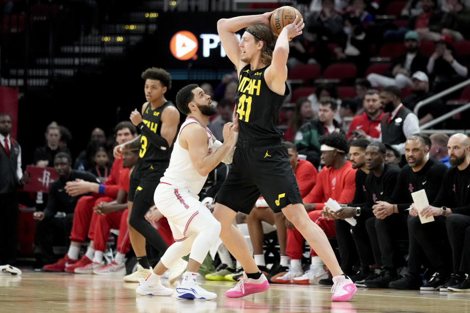 Utah Jazz forward Kelly Olynyk (41) looks to pass the ball as Houston Rockets guard Fred VanVleet, center left, defends during the first half of an NBA basketball game Saturday, Jan. 20, 2024, in Houston. (AP Photo/Eric Christian Smith)