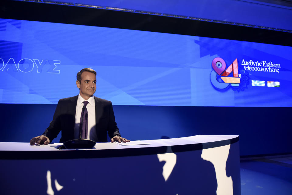 Greece's Prime Minister Kyriakos Mitsotakis waits for a news conference to start during the Thessaloniki International Fair at the northern city of Thessaloniki, Sunday, Sept. 8, 2019. Greece's prime minister said on Saturday that financial reforms such as reducing taxes, fighting bureaucracy and attracting investment must be implemented before the country asks its creditors to agree to lower budget surpluses. (AP Photo/Giannis Papanikos)