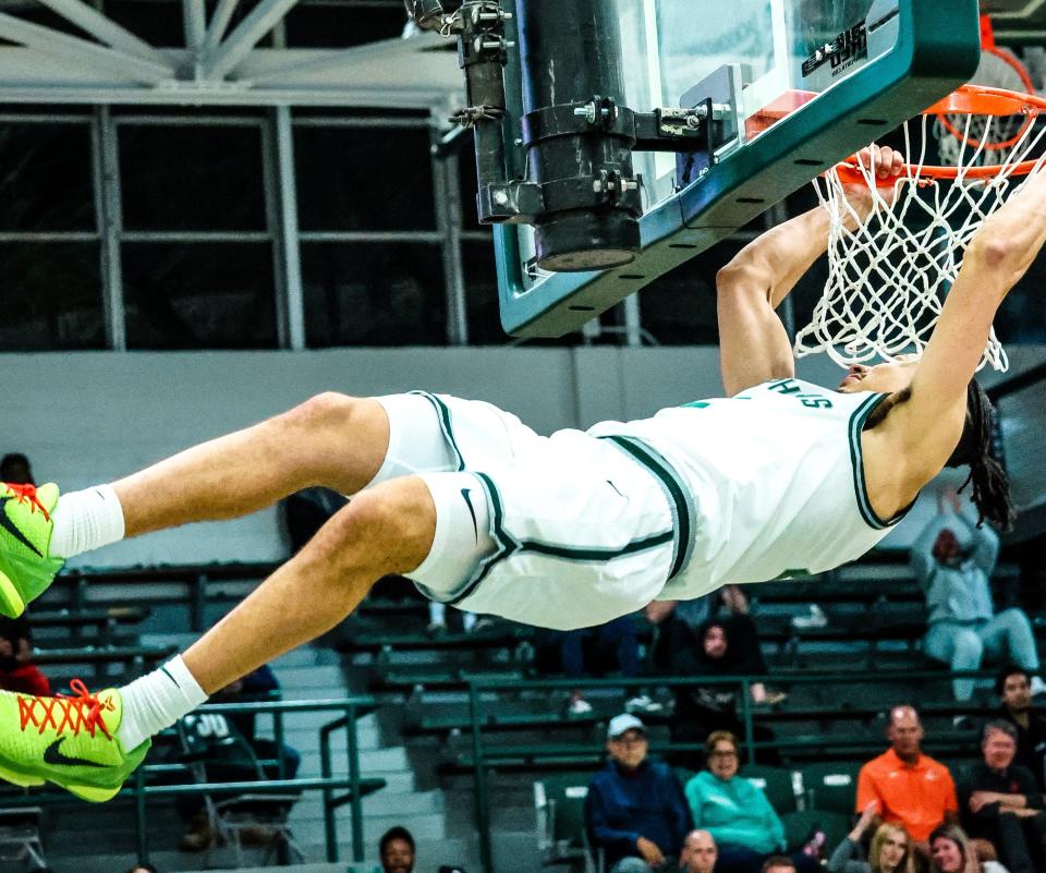 Josh Sabino of Orange Park follows through on a dunk for the Jacksonville University Dolphins in their 113-46 victory over Johnson (Fla.) on Nov. 6 at Swisher Gym.