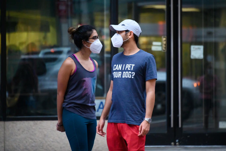 NEW YORK, NEW YORK - MAY 30:  People wear protective face masks in Murray Hill during the coronavirus pandemic on May 30, 2020 in New York City. Government guidelines encourage wearing a mask in public with strong social distancing in effect as all 50 US states have begun to slowly reopen after weeks of stay-at-home measures to control the spread of COVID-19. (Photo by Noam Galai/Getty Images)