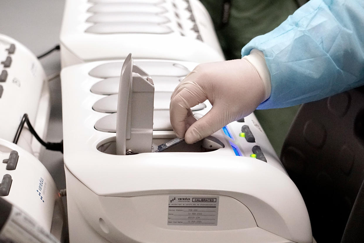 Home Team Science and Technology Agency (HTX) scientist demonstrating how the new COVID-19 test kit is used to detect the virus on 5 March 2020. (PHOTO: Dhany Osman / Yahoo News Singapore)