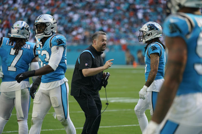 Carolina Panthers head coach Matt Rhule, center, talks to his players during the first half of an NFL football game against the Miami Dolphins, Sunday, Nov. 28, 2021, in Miami Gardens, Fla. (AP Photo/Lynne Sladky)