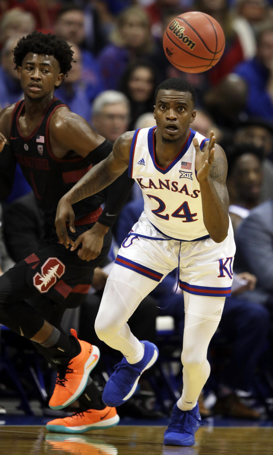 Kansas guard Lagerald Vick (24) steals the ball from Stanford guard Daejon Davis (1) during the first half of an NCAA college basketball game in Lawrence, Kan., Saturday, Dec. 1, 2018. (AP Photo/Orlin Wagner)