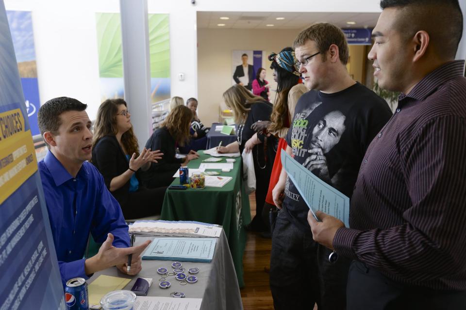 In this April 10, 2014 photo, John Soung, right, and Gabriel Fitzgerald, second right, talk to recruiter Todd Zedicher of Integrated Life Choices, left, at a job fair on the campus of Kaplan University in Lincoln, Neb. The Labor Department on Friday, May 2, 2014 said U.S. employers added a robust 288,000 jobs in April, the most in two years, the strongest evidence to date that the economy is picking up after a brutal winter slowed growth. (AP Photo/Nati Harnik)