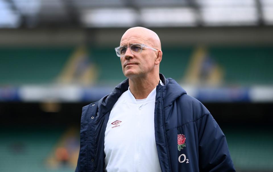 England head coach John Mitchell walks around the Twickenham pitch