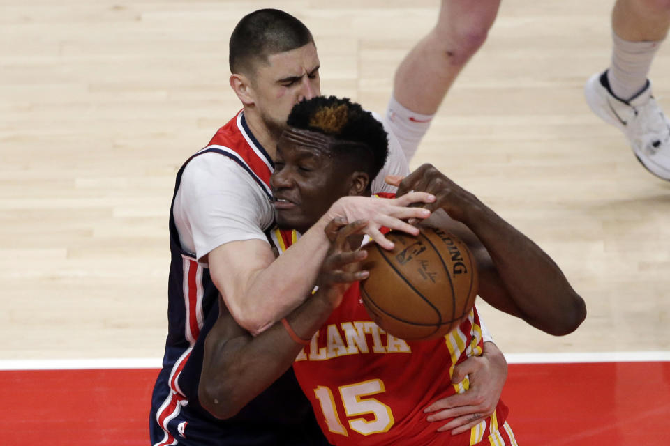 Atlanta Hawks center Clint Capela (15) is fouled by Washington Wizards center Alex Len (27) as he drives to the basket during the first half of an NBA basketball game Wednesday, May 12, 2021, in Atlanta. (AP Photo/Butch Dill)
