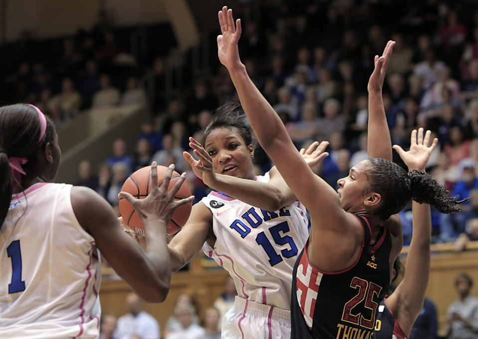 Duke's Richa Jackson (15) passes to teammate Elizabeth Williams (1) while defended by Maryland's Alyssa Thomas (25) during the first half of an NCAA college basketball game in Durham, N.C., Monday, Feb. 17, 2014. (AP Photo/Ted Richardson)