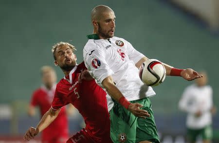 Bulgaria's Andrej Galabinov (R) is challenged by Malta's Andre Aglus during their Euro 2016 Group H qualification soccer match at Vassil Levski stadium in Sofia November 16, 2014. REUTERS/Stoyan Nenov