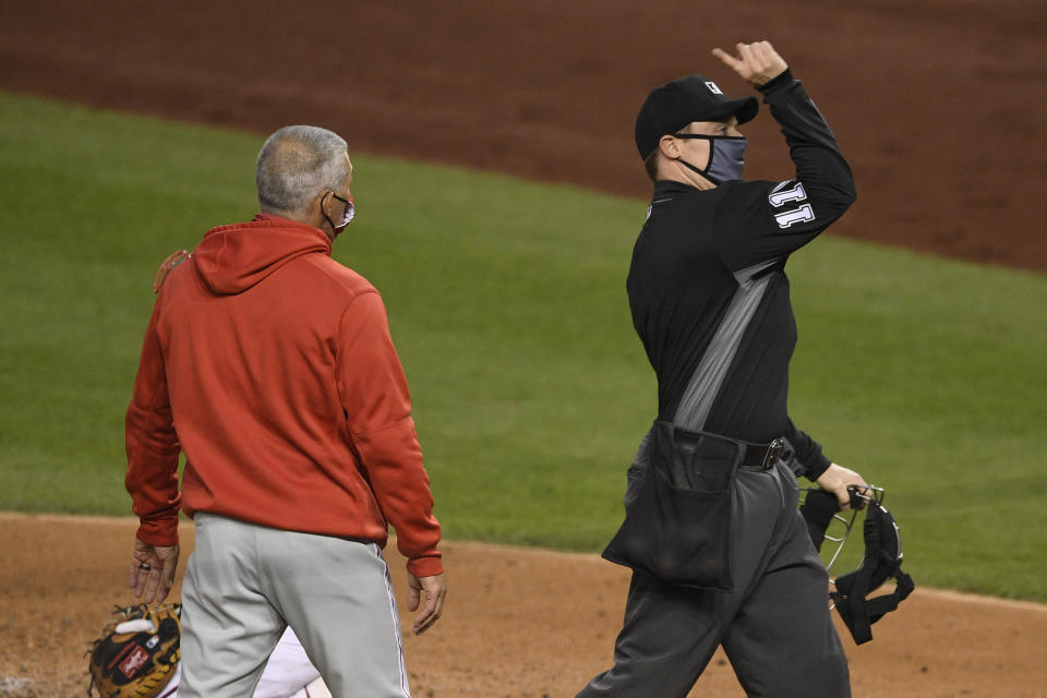 Home plate umpire Junior Valentine, right, ejects Philadelphia Phillies manager Joe Girardi, left, during the third inning of a baseball game against the Washington Nationals, Monday, Sept. 21, 2020, in Washington. (AP Photo/Nick Wass)