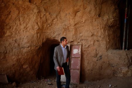 Archaeologist Musab Mohammed Jassim shows artefacts and archaeological pieces in a tunnel network running under the Mosque of Prophet Jonah, Nabi Yunus in Arabic, in eastern Mosul, Iraq March 9, 2017. REUTERS/Suhaib Salem