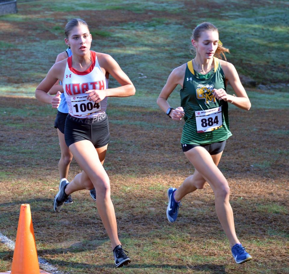 North Hagerstown's Lauren Stine and Great Mills' Carter Brotherton run side by side in the first mile of the Maryland Class 3A girls race. Brotherton won in 18:33.65 and Stine placed third in 19:10.48.