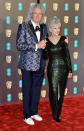 <p>Brian May a opté pour un smoking à motifs, et Anita Dobson pour une robe pailletée impressionnante. <em>[Photo: Getty]</em> </p>