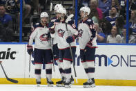 Columbus Blue Jackets right wing Kirill Marchenko (86) celebrates his goal against the Tampa Bay Lightning with left wing Dmitri Voronkov (10), left wing Johnny Gaudreau (13), and center Alexandre Texier (42) during the second period of an NHL hockey game Tuesday, April 9, 2024, in Tampa, Fla. (AP Photo/Chris O'Meara)