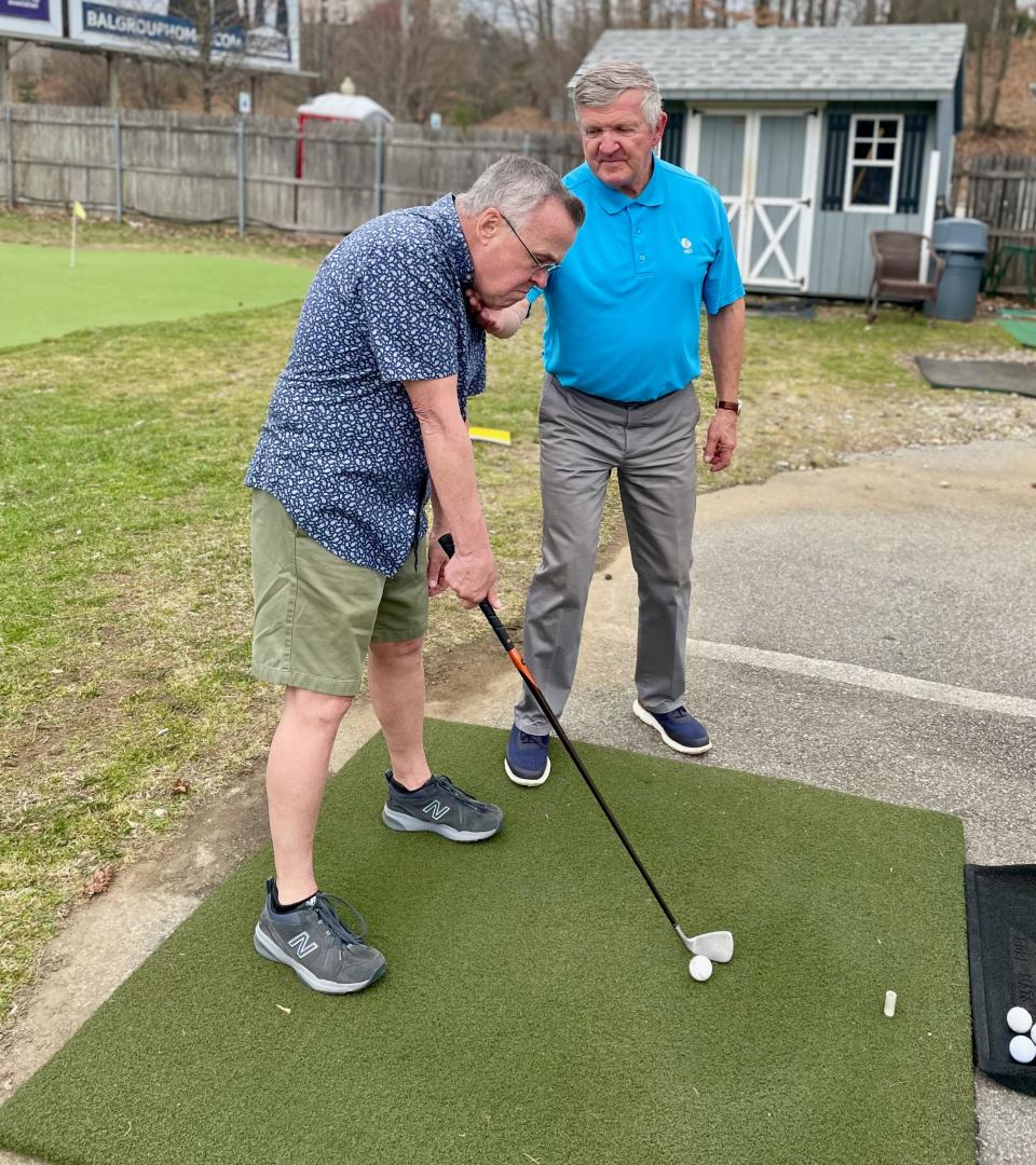 Rick Karbowski offers tips to Auburn's Jerry Hastings during a recent golf lesson at Auburn Driving Range.