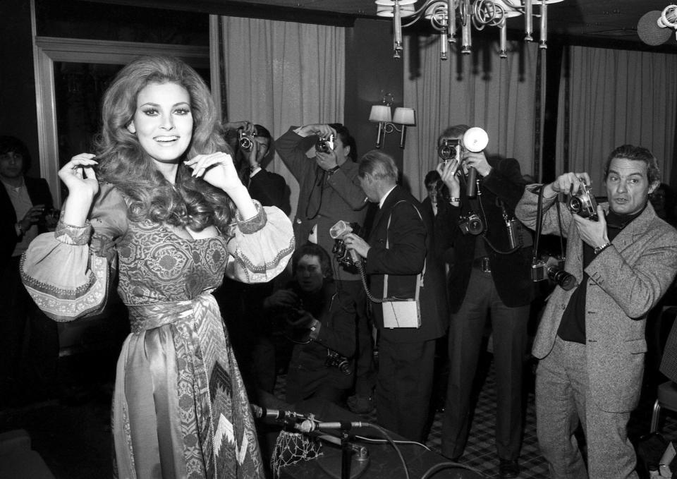 FILE - American actress Raquel Welch poses for photographers in Paris on Jan. 15, 1970. Welch, whose emergence from the sea in a skimpy, furry bikini in the film “One Million Years B.C.” would propel her to international sex symbol status throughout the 1960s and '70s, died early Wednesday, Feb. 15, 2023, after a brief illness. She was 82. (AP Photo/Michel Lipchitz, File)