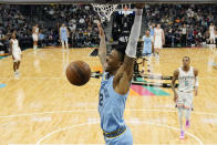 Memphis Grizzlies guard Ja Morant (12) scores against the San Antonio Spurs during the second half of an NBA basketball game, Wednesday, Jan. 26, 2022, in San Antonio. (AP Photo/Eric Gay)