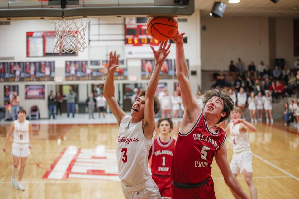 Oklahoma Union's Kade Hollingshed, No. 5, blocks a shot by Dewey's Hunter Perrier during recent action.