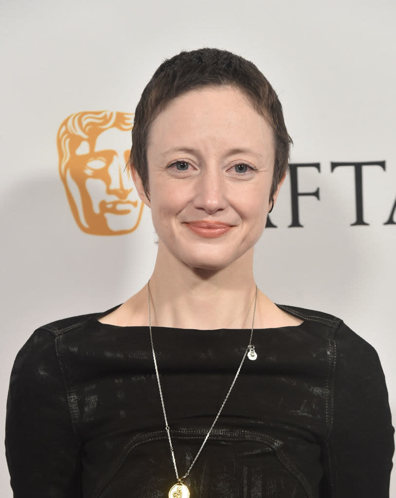 A closeup of Andrea Riseborough smiling and rocking a close-cropped haircut