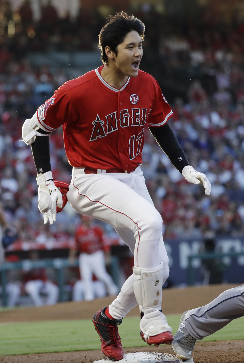 Los Angeles Angels' Shohei Ohtani reaches first base with an RBI infield single against the Houston Astros during the first inning of a baseball game Tuesday, July 16, 2019, in Anaheim, Calif. (AP Photo/Marcio Jose Sanchez)