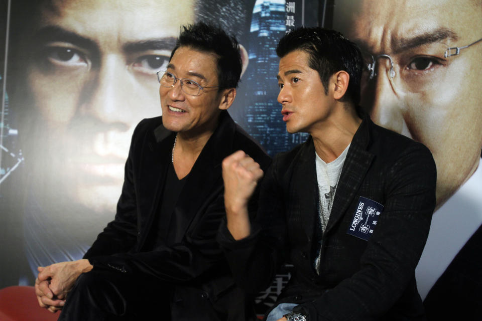 In this photo taken on Monday, Nov. 12, 2012, Hong Kong actors Aaron Kwok, right, and Tony Leung Ka Fai speak during an interview for their new film "Cold War" in Taipei, Taiwan. (AP Photo/Chiang Ying-ying)