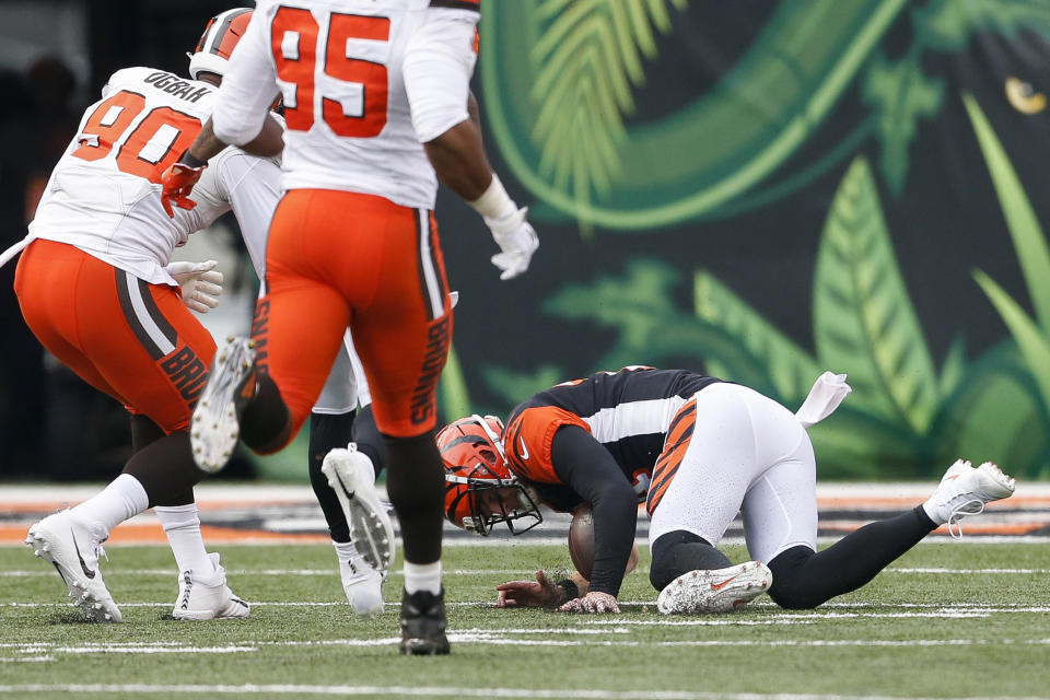 Cincinnati Bengals quarterback Andy Dalton, right, fails to recover a fumble in the second half of an NFL football game against the Cleveland Browns, Sunday, Nov. 25, 2018, in Cincinnati. (AP Photo/Gary Landers)