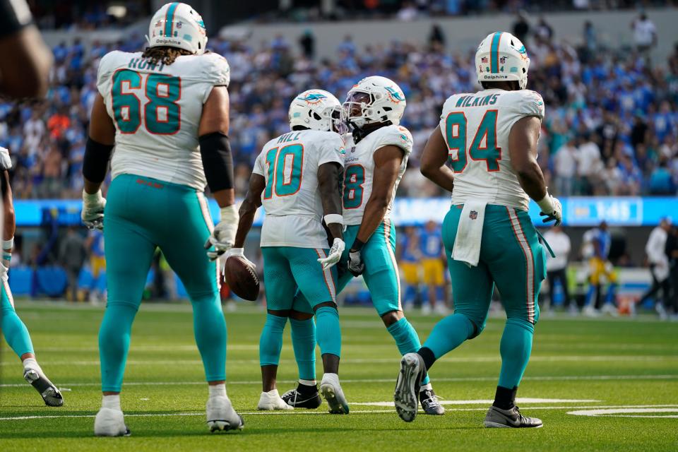 Miami Dolphins wide receiver Tyreek Hill (10) celebrates his touchdown catch with wide receiver Erik Ezukanma during the second half of an NFL football game Sunday, Sept. 10, 2023, in Inglewood, Calif. (AP Photo/Ashley Landis)