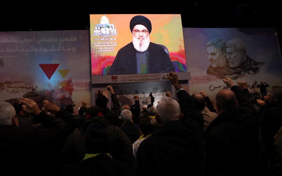 People watch the televised speech of Lebanon's Hezbollah chief Hasan Nasrallah to mark the anniversary of the killing of Iranian commander Qasem Soleimani, in Beirut on Jan 3