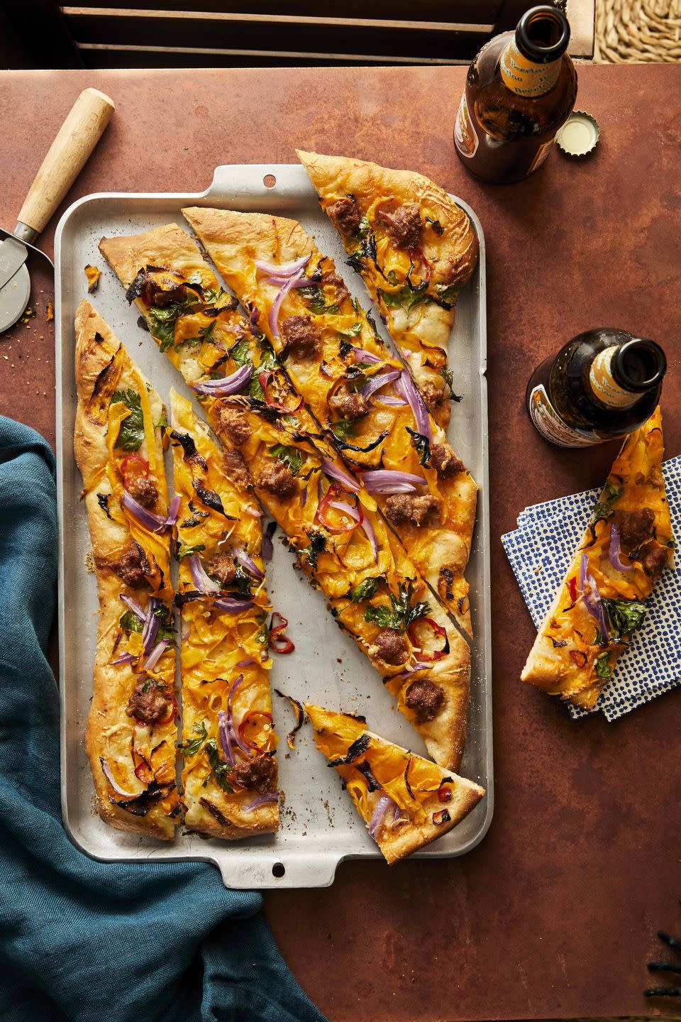 pumpkin chorizo pizza on a sheet pan and cut into slices