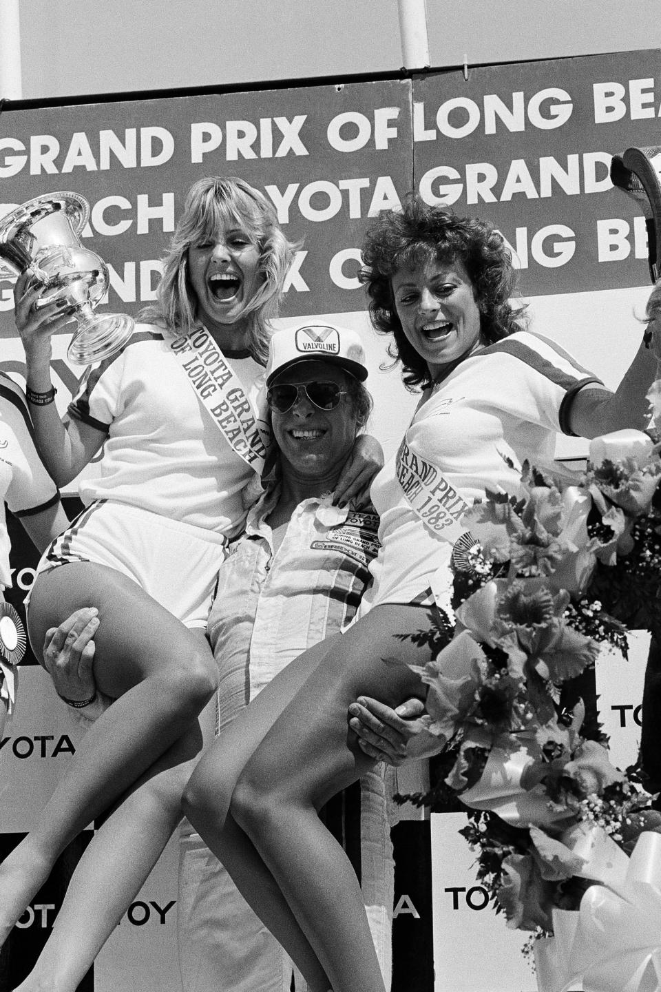 FILE - Rock Star Ted Nugent celebrates in the winners circle with hosts Long Beach Grand Prix Princess Cynthia Pressimone, left, and Kara Karr after he won the Toyota Pro-Celebrity race on the Grand Prix circuit in Long Beach, Calif., in this March 26, 1983, file photo. The city closed its downtown streets for the first time in 1975 to host a street race that became one of the most prestigious events in both motorsports but also for successful, annual festivals. AP Photo/Lennox McLendon, File)