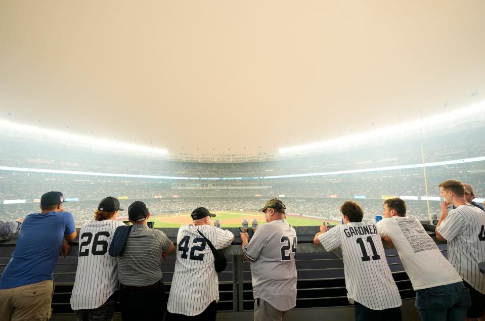 Yankee fans watch the game against the White Sox as a thick haze from the Canadian wildfires hover over The Bronx. Tuesday, June 6, 2023 