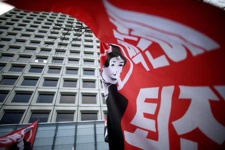 A flag with the image of South Korean President Park Geun-hye and a message "Step down, Park Geun-hye" flutters in front of Samsung's main building during a general strike calling for Park to step down, in central Seoul, South Korea November 30, 2016. REUTERS/Kim Hong-Ji