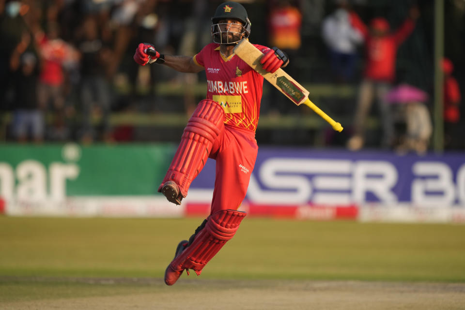 Zimbabwe batsman Sikandar Raza celebrates after scoring 100 runs on the last day of the One-Day International cricket match between Zimbabwe and India at Harare Sports Club in Harare, Zimbabwe, Monday, Aug, 22, 2022. (AP Photo/Tsvangirayi Mukwazhi)