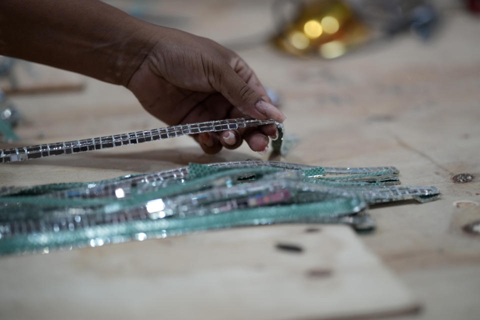 A worker from the Paraiso do Tuiuti samba school prepares a float at the Samba City complex in Rio de Janeiro, Brazil, Thursday, Feb. 9, 2023. Samba schools are already gearing up for next Carnival, building the colorful floats and stitching together the costumes. (AP Photo/Silvia Izquierdo)