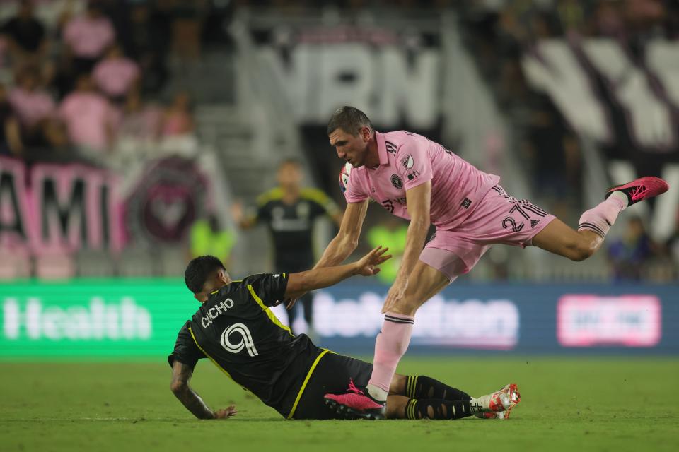 Jul 4, 2023; Fort Lauderdale, Florida, USA; Inter Miami defender Serhiy Kryvtsov (27) fouls Columbus Crew SC forward Cucho Hernandez (9) during the second half at DRV PNK Stadium. Mandatory Credit: Sam Navarro-USA TODAY Sports