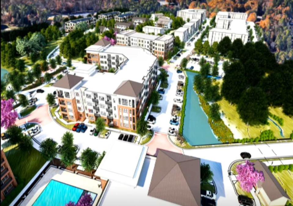 A bird’s eye view of Hillmont, at Barbee Chapel Road and NC 54, shows three apartment buildings at the development’s core (left, front) with the approved Barbee Chapel Apartments in the background. A restored stream is at bottom right.