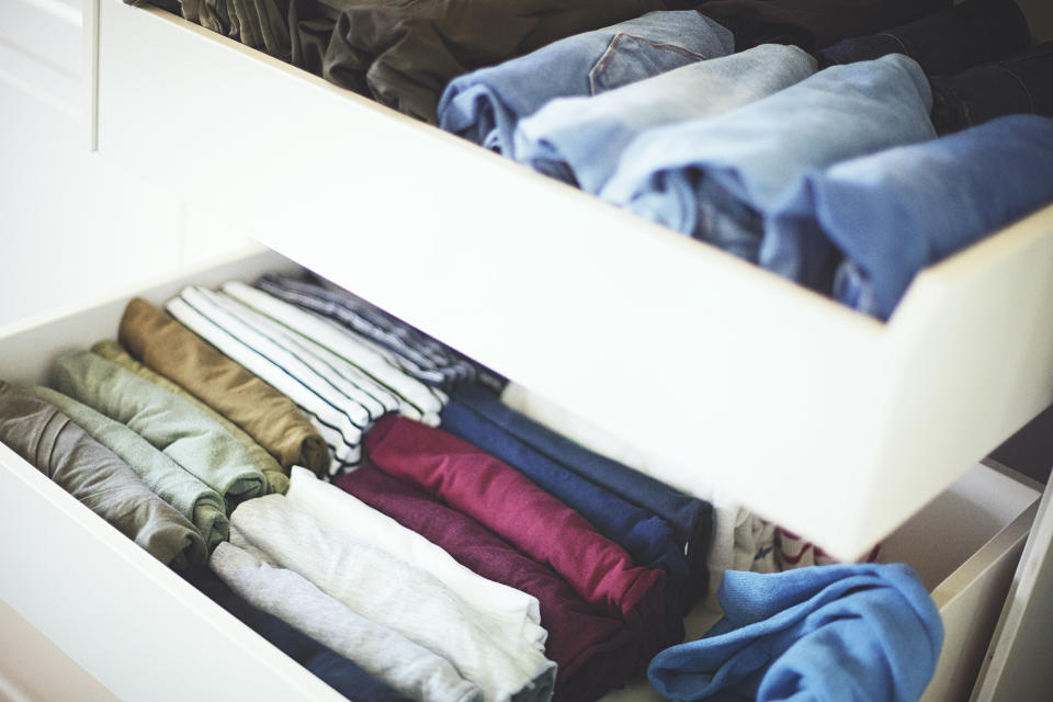 Folded clothes stored vertically in drawers