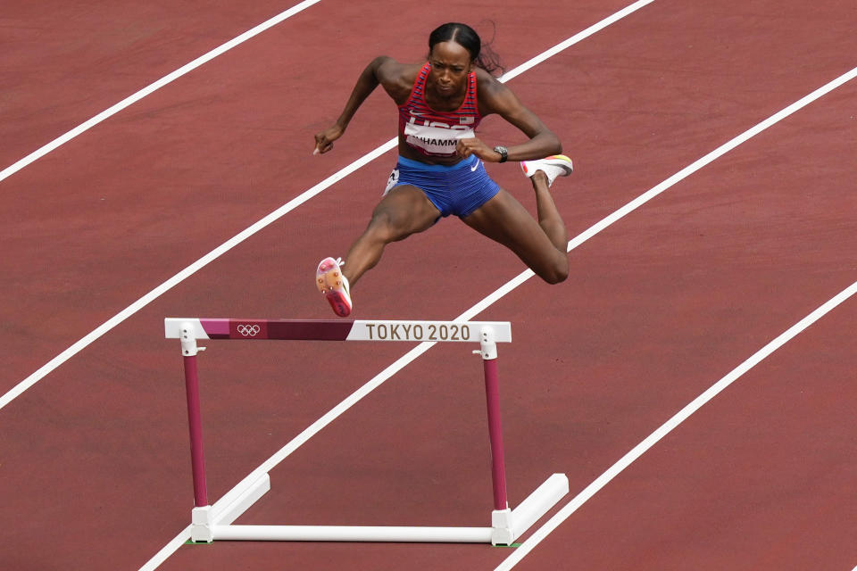 Dalilah Muhammad, of United States, wins a heat in the women's 400-meter hurdles at the 2020 Summer Olympics, Saturday, July 31, 2021, in Tokyo. (AP Photo/Martin Meissner)