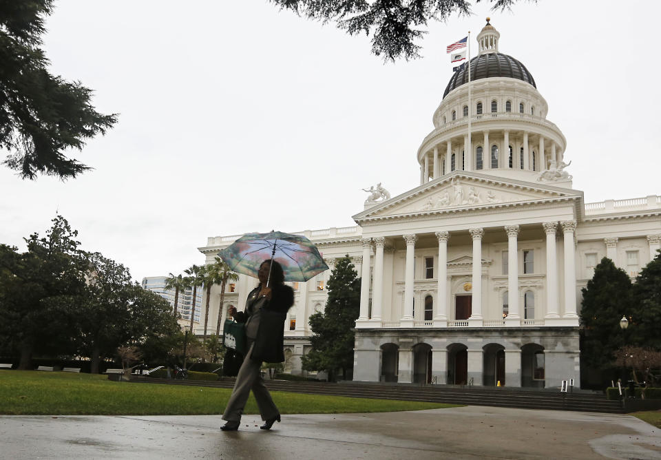 After a 52 day dry spell, umbrella were finally in need as the first storm of the new year moved into in Sacramento, Calif., Wednesday, Jan. 29, 2014. Storms are expected to move through Northern California bringing to the valley and snow to the mountains to help relieve the parched landscape. (AP Photo/Rich Pedroncelli)