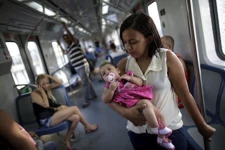 Luana Vieira, 4 months, who was born with microcephaly, is held by her mother Rosana Vieira Alves as they ride the subway after a doctor's appointment in Recife, Brazil, February 3, 2016. REUTERS/Ueslei Marcelino
